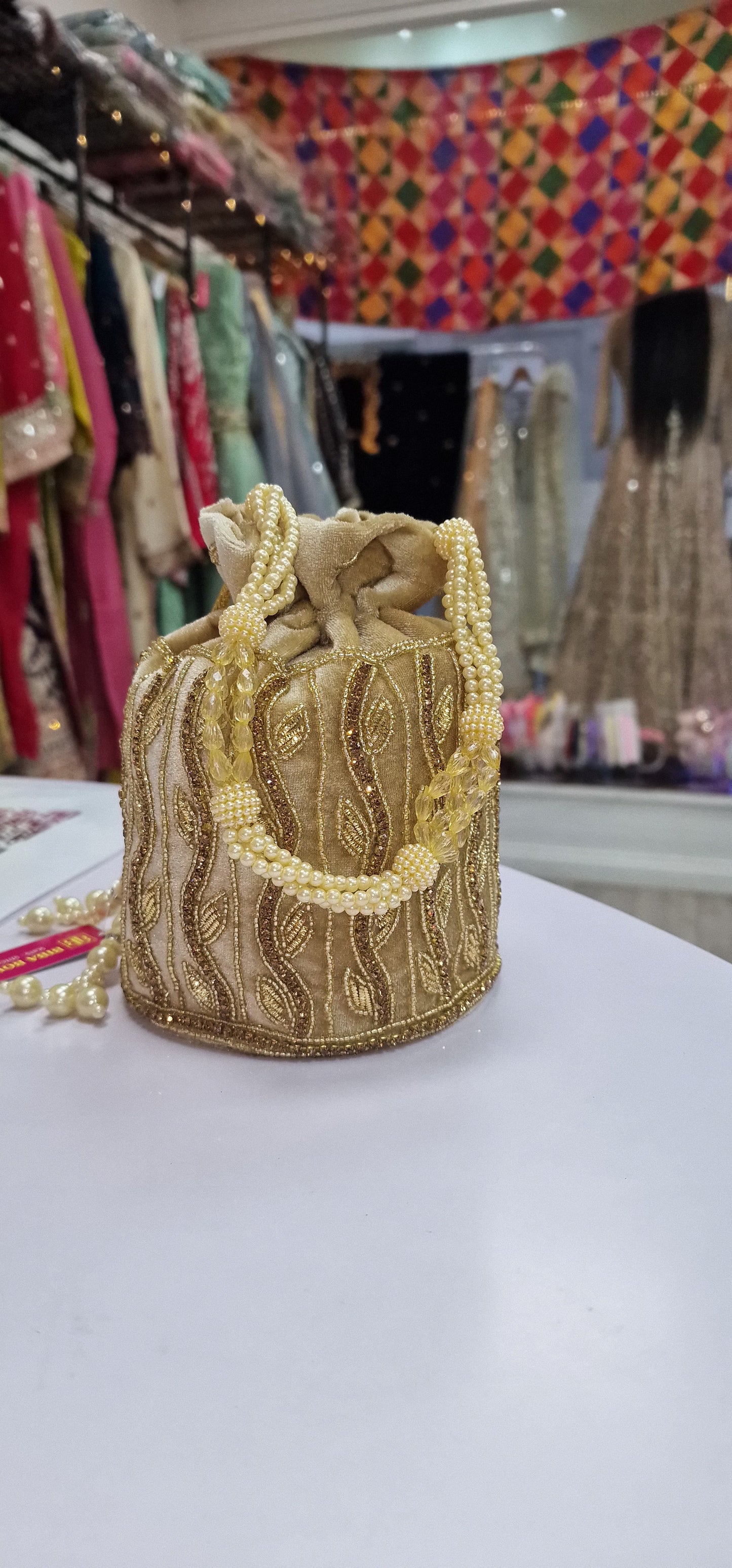 Golden, hand embroidered Potli Bag made in Velvet