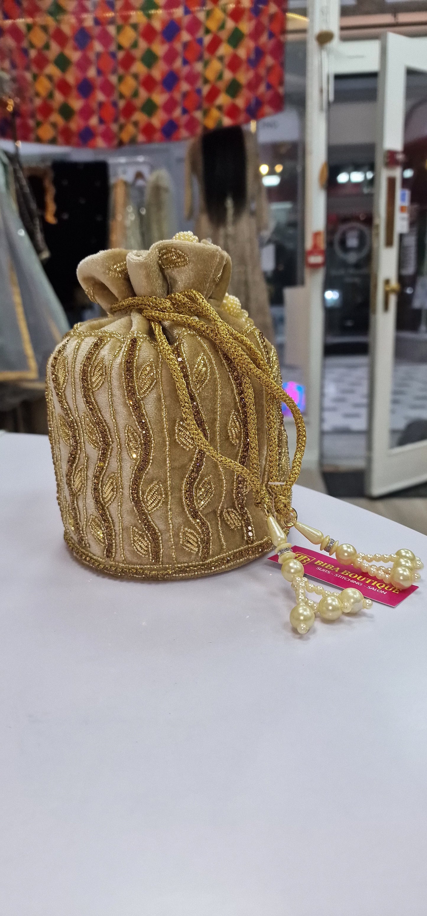 Golden, hand embroidered Potli Bag made in Velvet