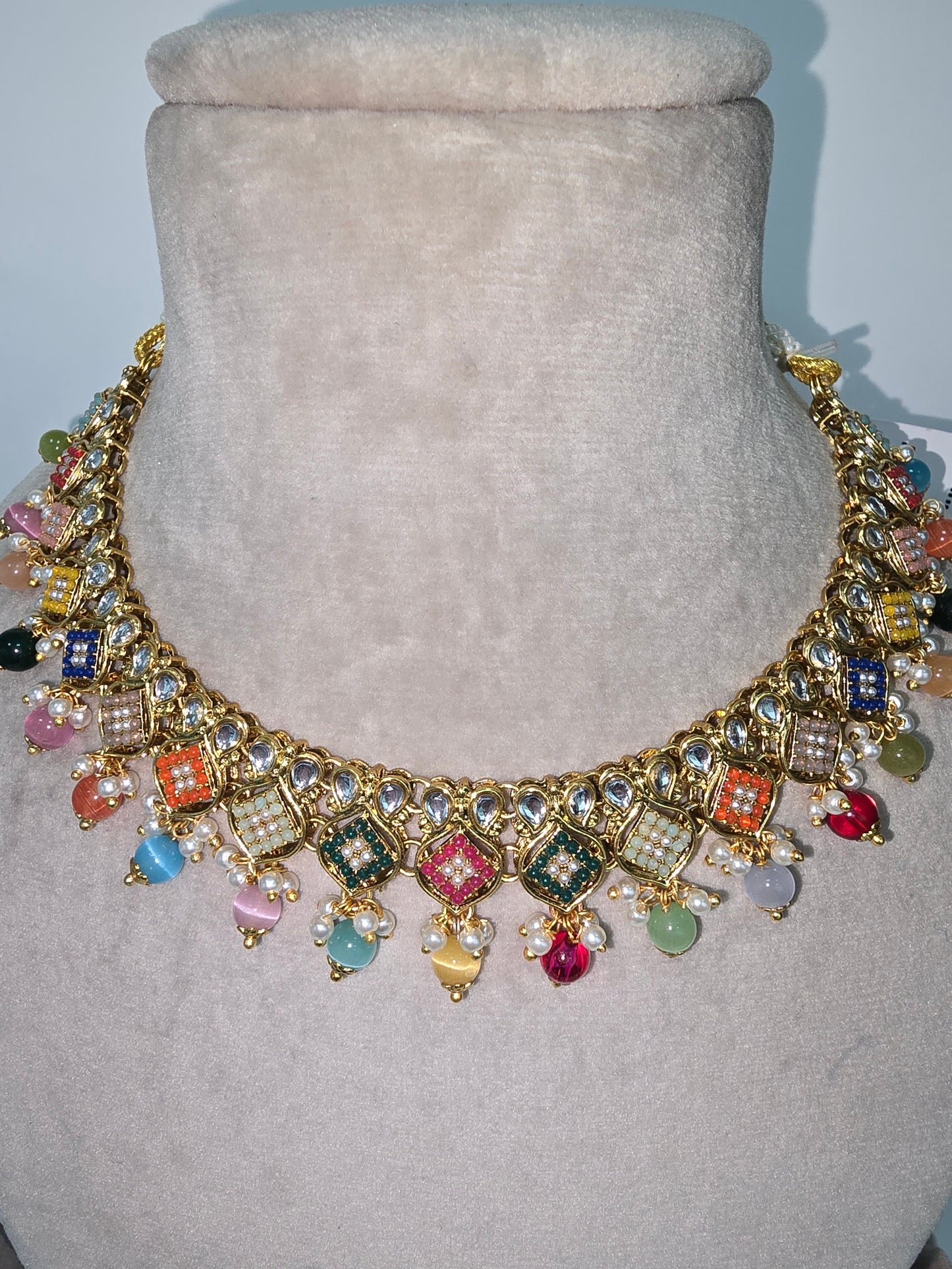 Cream and multi coloured Asian designer sets with earrings n tikka